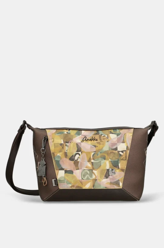 Brown leather crossbody bag with a colorful camo front panel and metal charm keychain