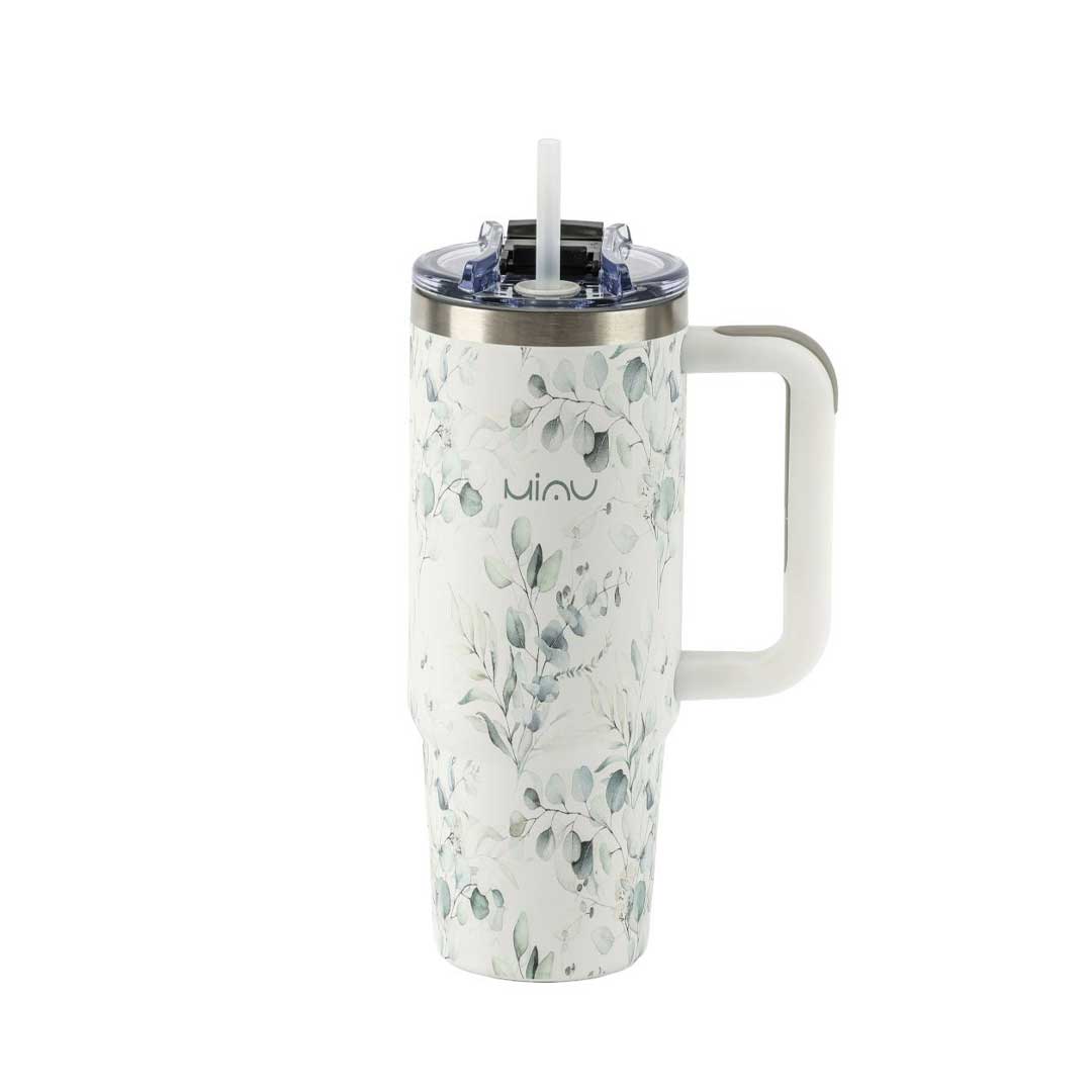 White travel tumbler with a delicate green leaf pattern and a built-in straw lid, matching handle on the side.