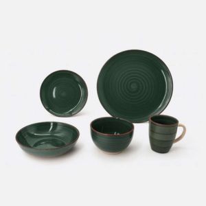 Dark green ceramic dishware set: two plates, two bowls, a shallow bowl, and a mug on a white background.